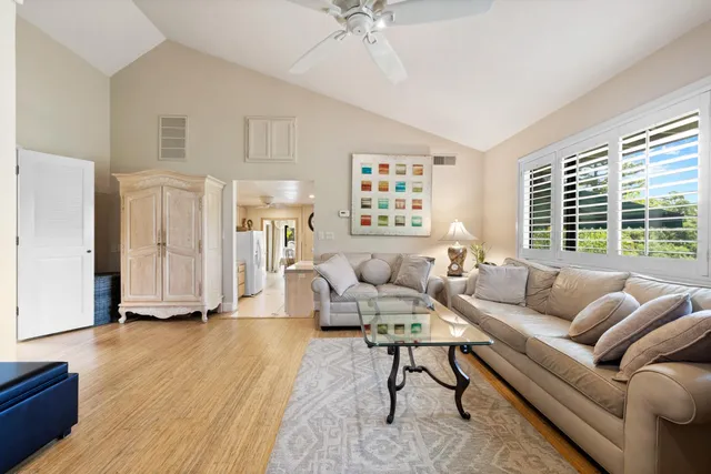 a kitchen with stainless steel appliances granite countertop a sink a stove a refrigerator with a dining table and chairs