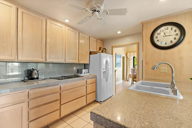 a kitchen with a refrigerator and a sink