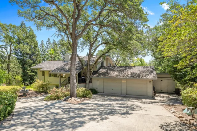 a view of a house with a tree beside it