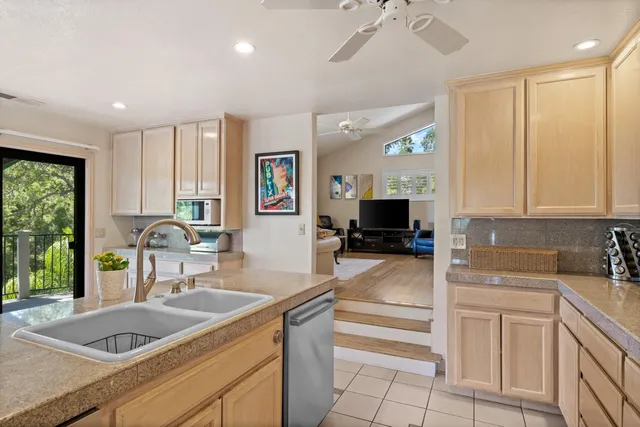 a spacious bedroom with a large bed and a chandelier