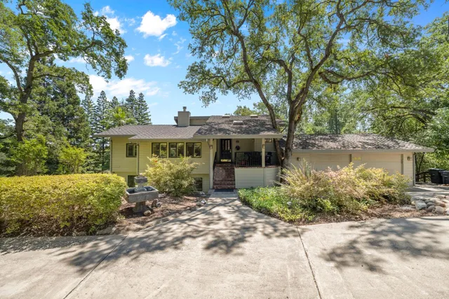 a front view of a house with a garden