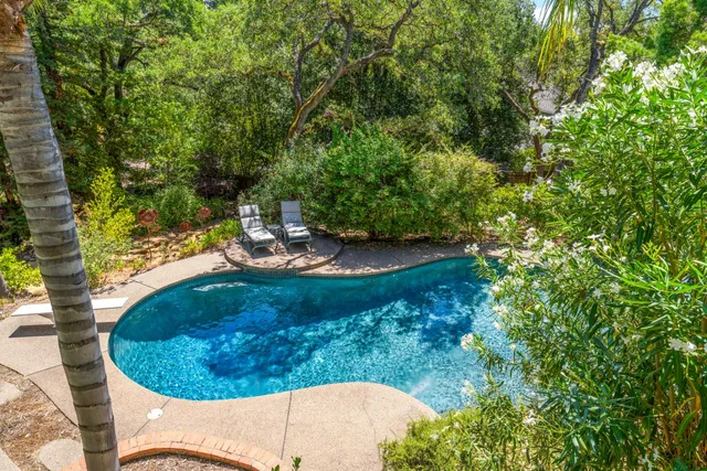 a view of a house with a yard and sitting area
