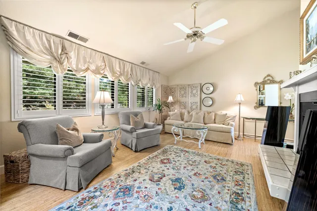 a living room with furniture a couch and wooden floor