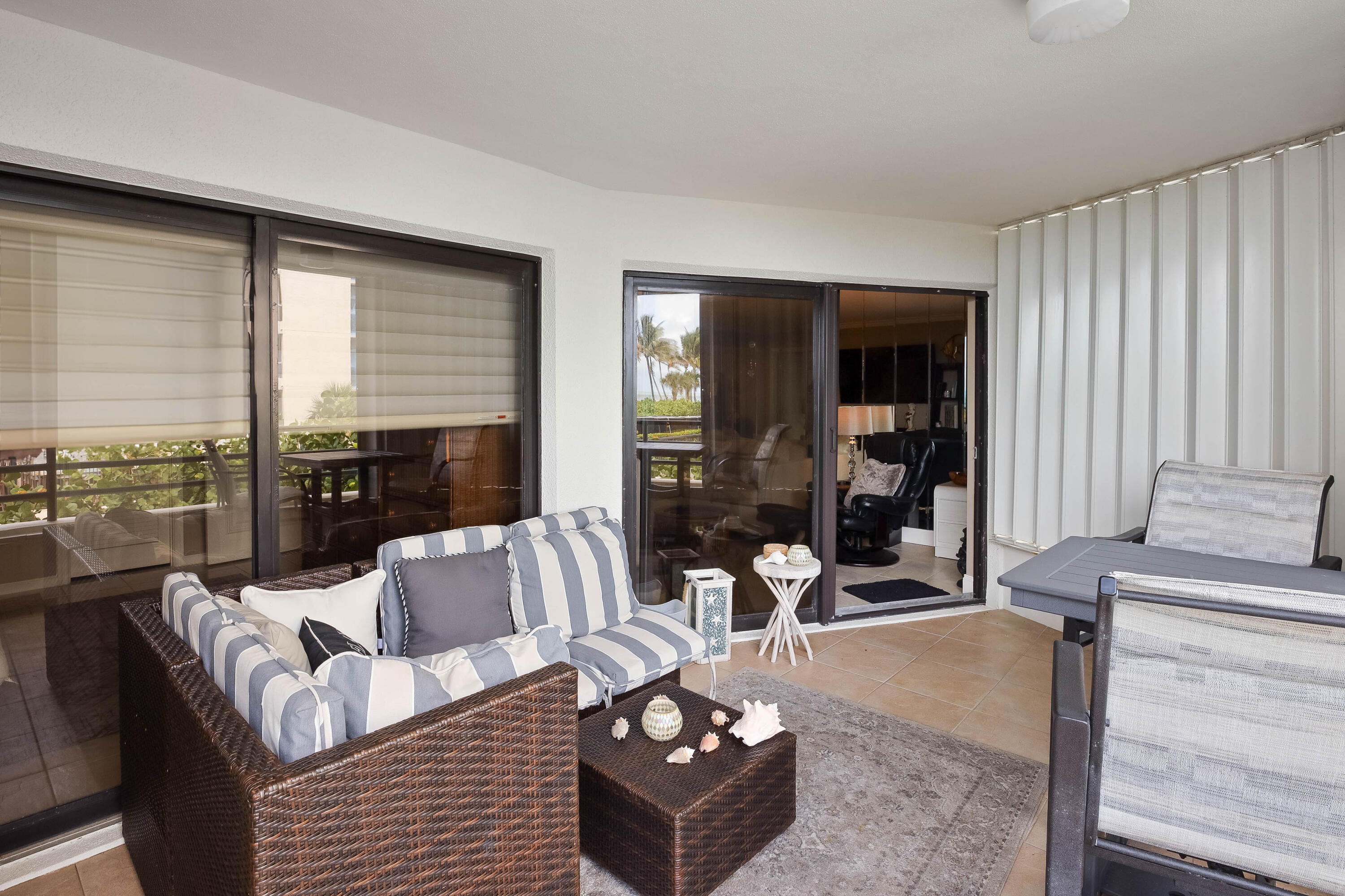 420 Celestial Way, Unit 204 Juno Beach, FL 33408 - Photo 13 of 35 a living room with furniture and a floor to ceiling window