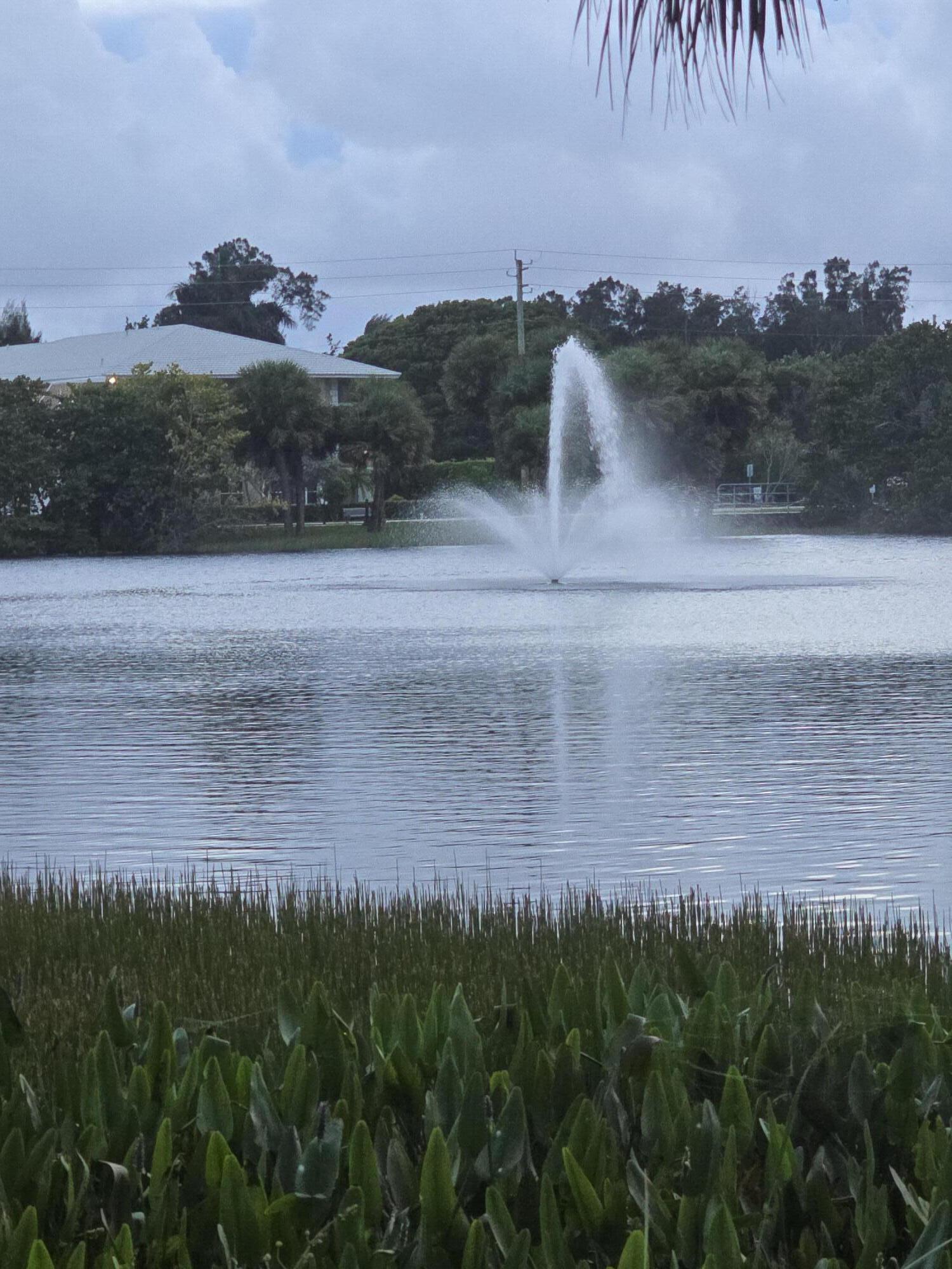 420 Celestial Way, Unit 204 Juno Beach, FL 33408 - Photo 32 of 35 a view of a yard next to a yard