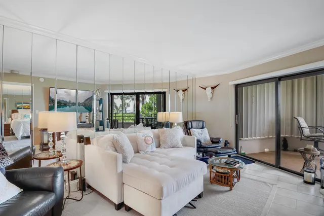 a view of a dining room with furniture and a chandelier
