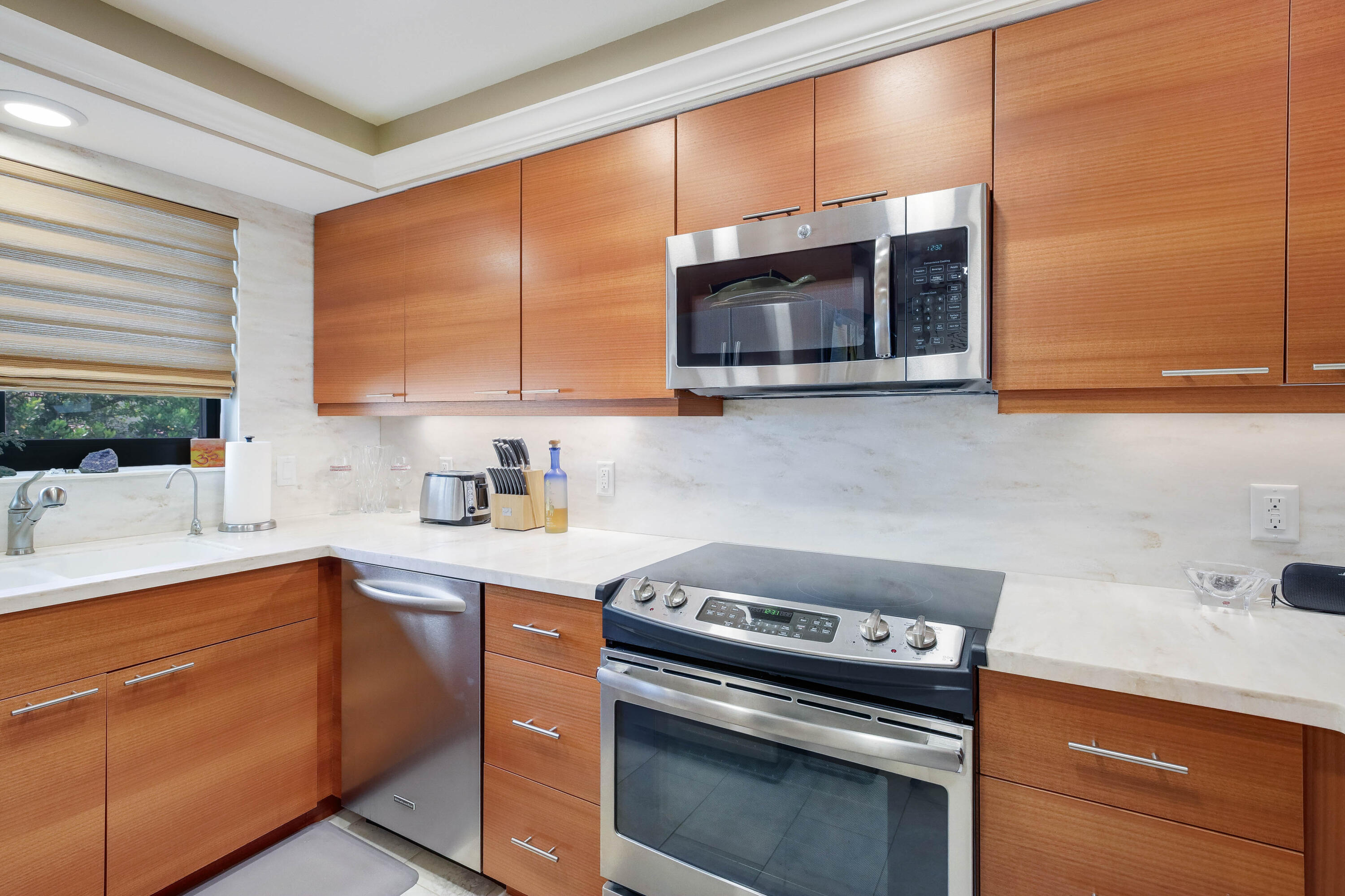 420 Celestial Way, Unit 204 Juno Beach, FL 33408 - Photo 8 of 35 a kitchen with stainless steel appliances a stove sink and microwave