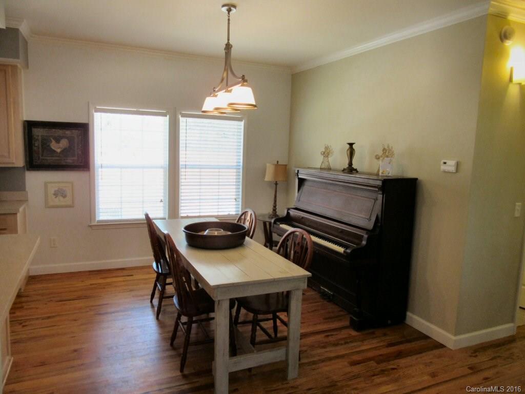 115 Coltons Way, Unit 2 Penrose, NC 28766 - Photo 4 of 14 a view of a dining room with furniture window and wooden floor