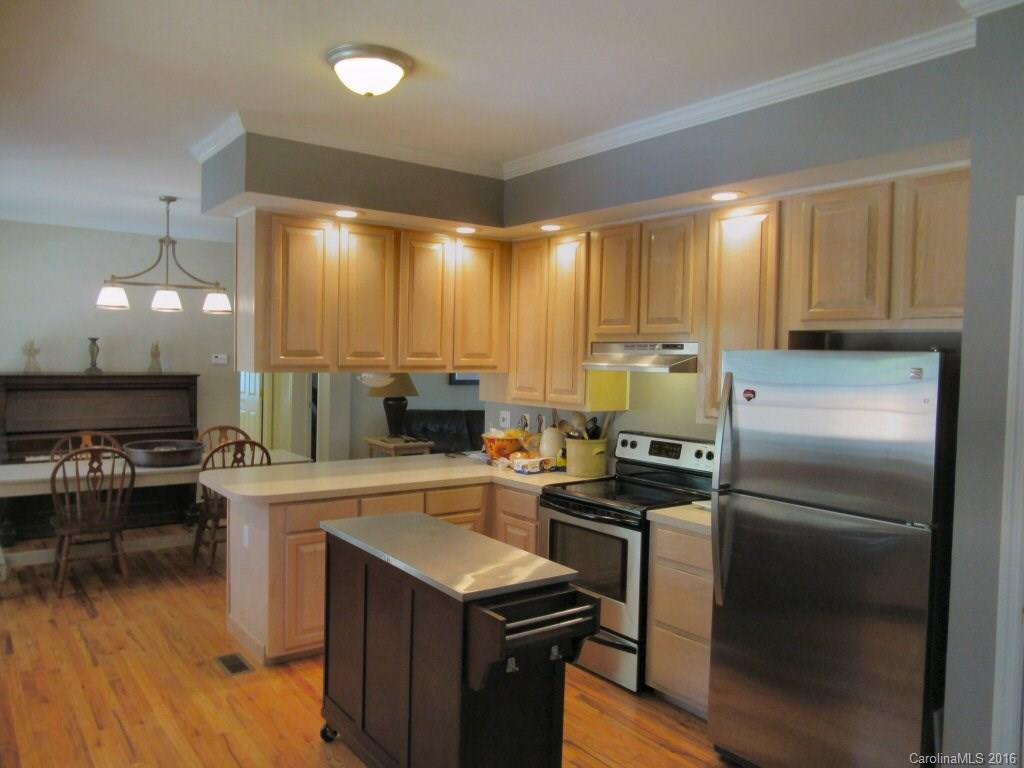115 Coltons Way, Unit 2 Penrose, NC 28766 - Photo 7 of 14 a kitchen with a refrigerator a stove a sink and a counter