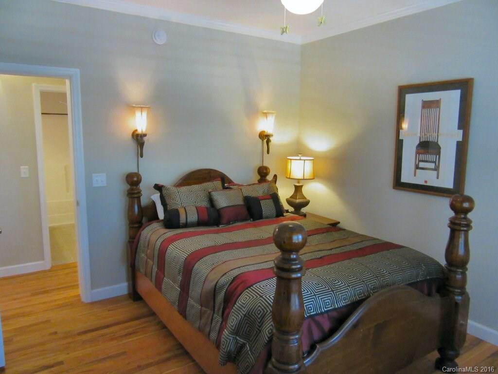 115 Coltons Way, Unit 2 Penrose, NC 28766 - Photo 10 of 14 a bedroom with a bed and a lamp