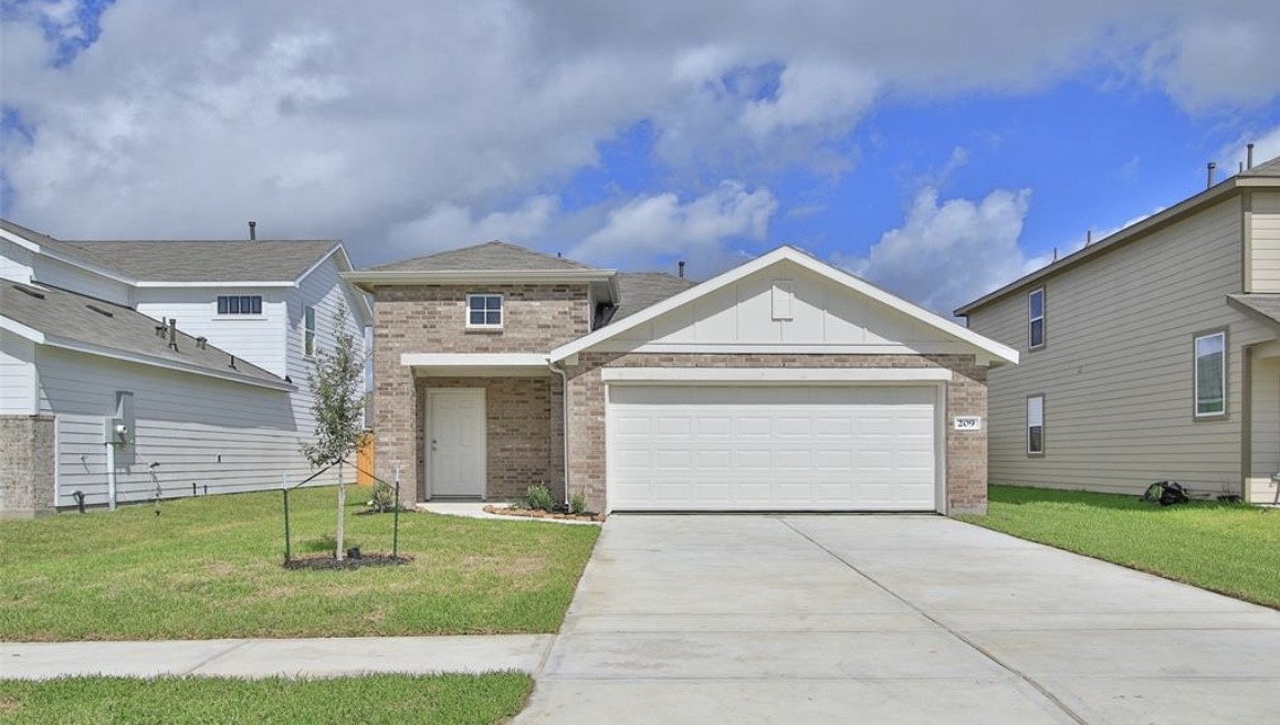 a view of a white house with a yard potted plants and a table