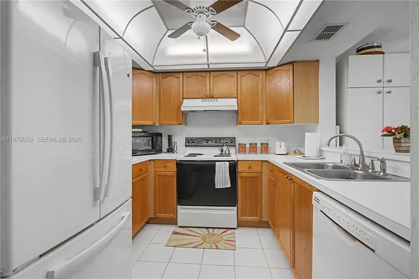 a kitchen with stainless steel appliances granite countertop a sink and cabinets