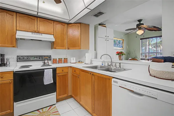 a kitchen with a sink cabinets and window