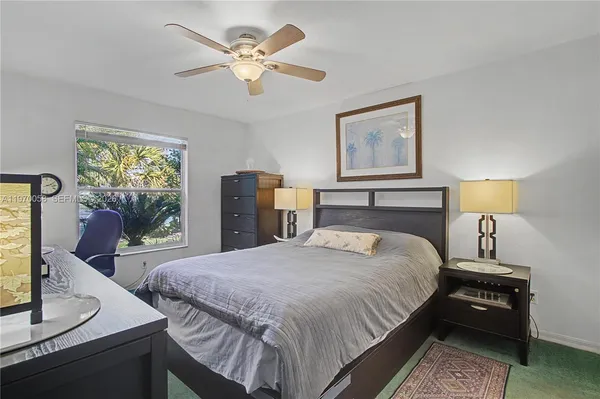 a bedroom with a bed and dresser with mirror