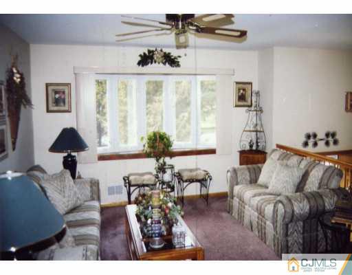 55 Ellison Road Somerset, NJ 08873 - Photo 2 of 8 a living room with furniture and a large window