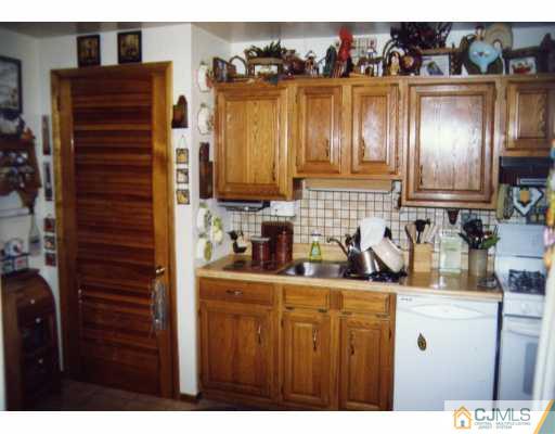 55 Ellison Road Somerset, NJ 08873 - Photo 3 of 8 a kitchen with a refrigerator and a sink