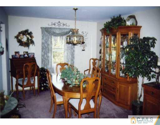 55 Ellison Road Somerset, NJ 08873 - Photo 4 of 8 a dining room with furniture potted plants and wooden floor