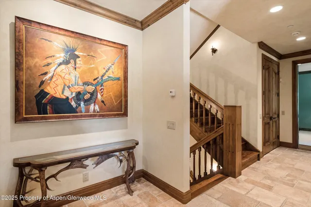 a view of staircase with a lots of frames on wall