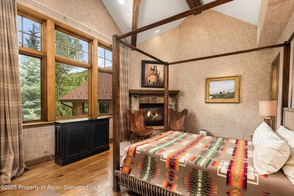 a bedroom with a bed and a fireplace