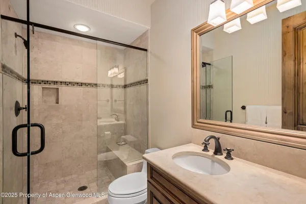 a spacious bathroom with a double vanity sink a mirror and shower