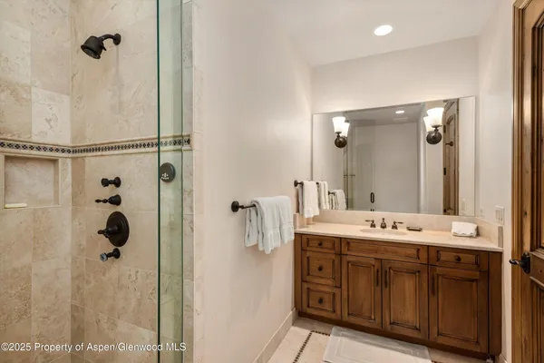 a bathroom with a shower and a sink
