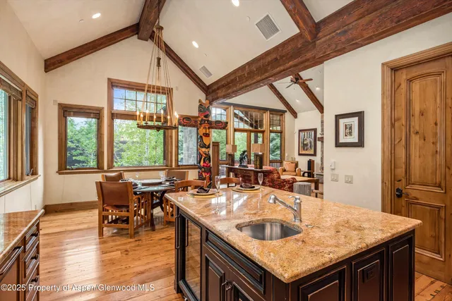a kitchen island with a table chairs and wooden floor