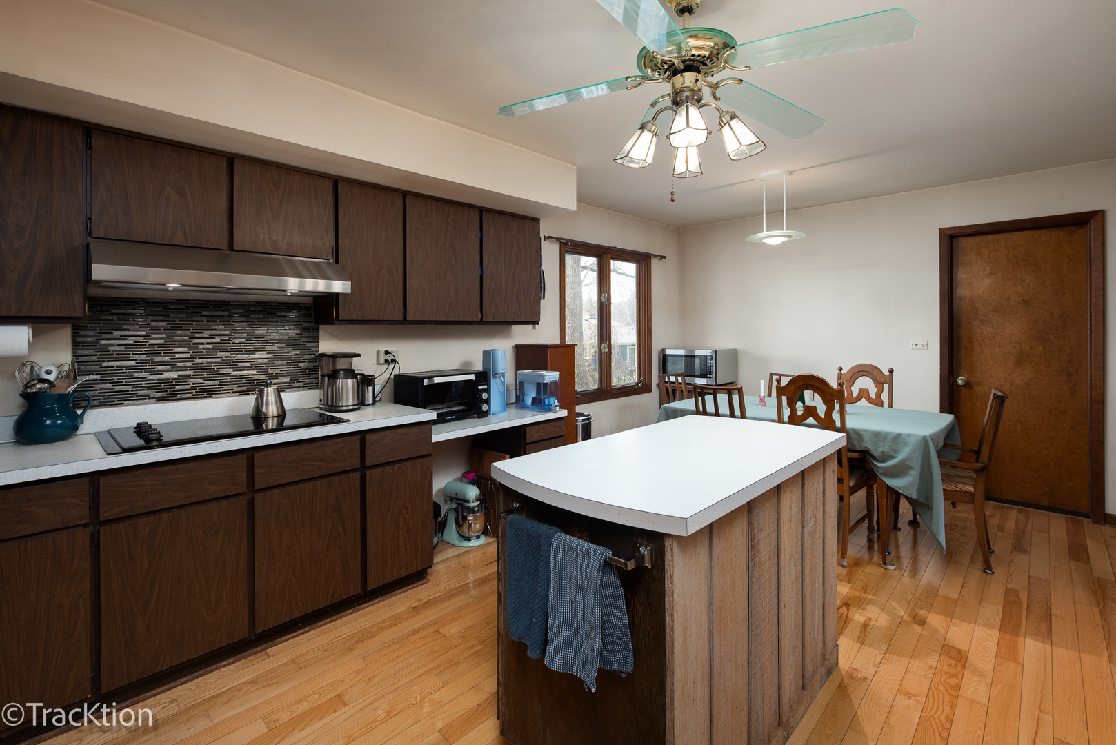 249 Surrey Road Bartlett, IL 60103 - Photo 5 of 28 a kitchen with kitchen island a sink table and chairs