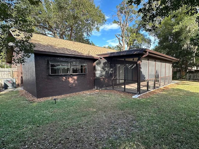 a view of a house with backyard and porch