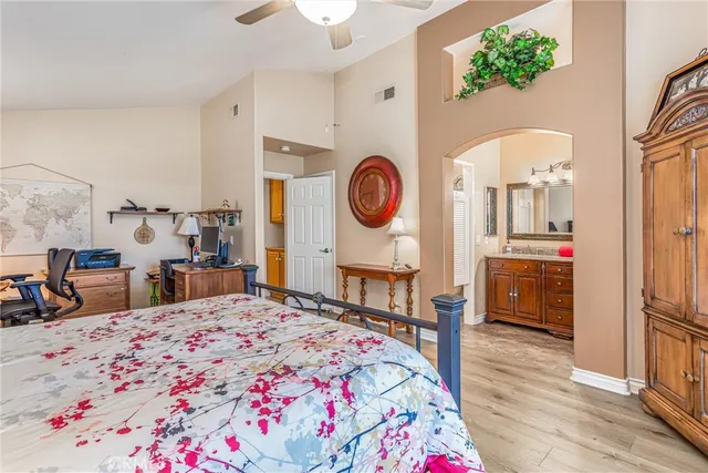 a bedroom with a bed a dresser and chair