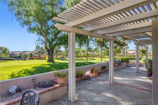 a view of a porch with furniture and garden