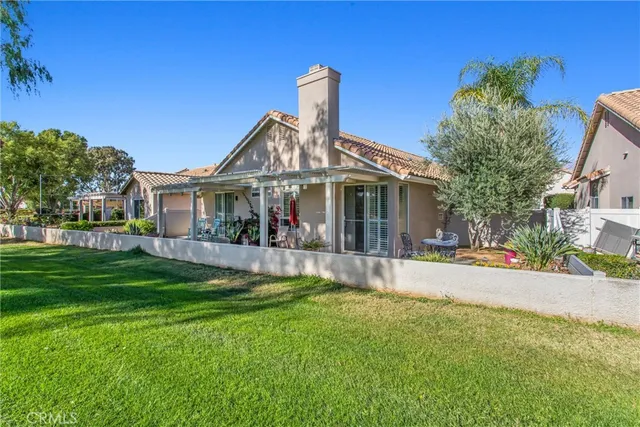a front view of a house with a garden and plants
