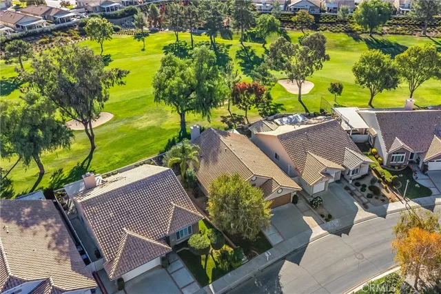 an aerial view of a house with a yard basket ball court and outdoor seating