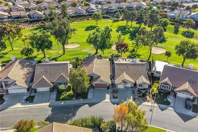 an aerial view of a house with a garden and swimming pool