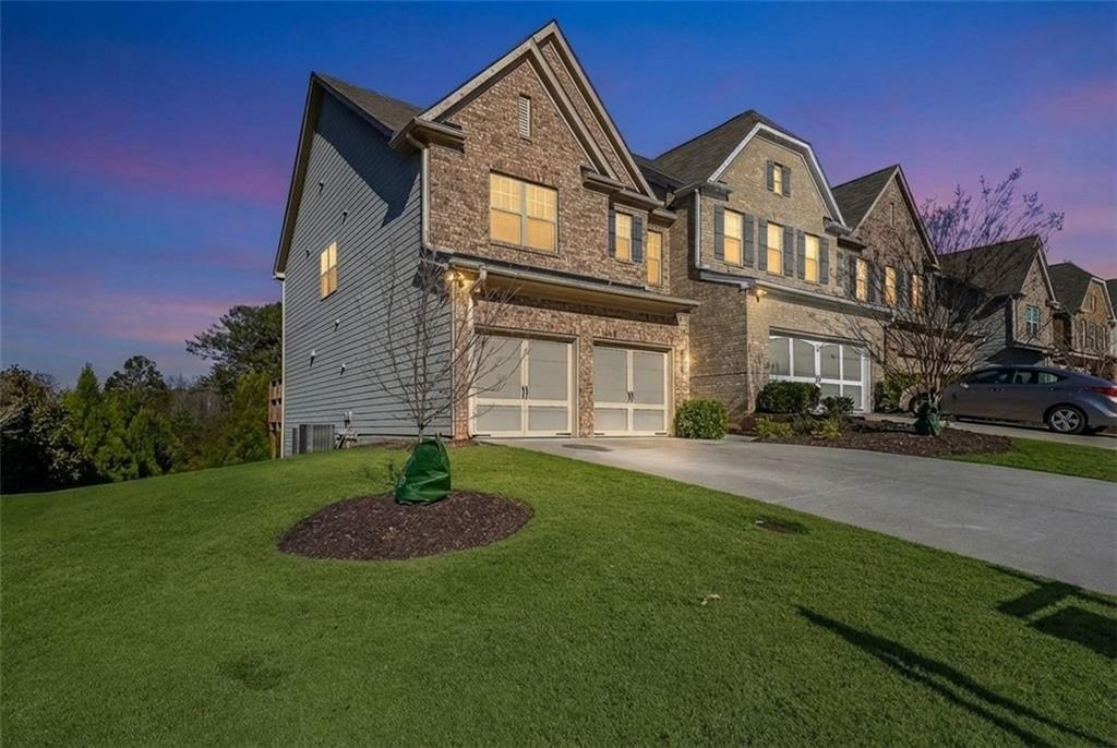 7065 Post Park Way Alpharetta, GA 30004 - Photo 1 of 1 a front view of a house with garden