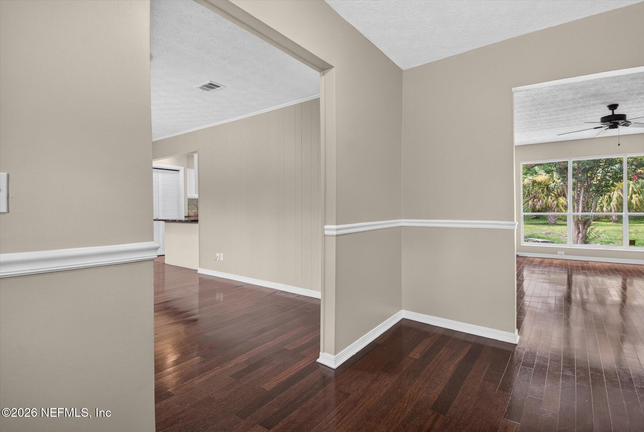 2705 Navajo Road Orange Park, FL 32073 - Photo 14 of 58 an empty room with wooden floor and windows