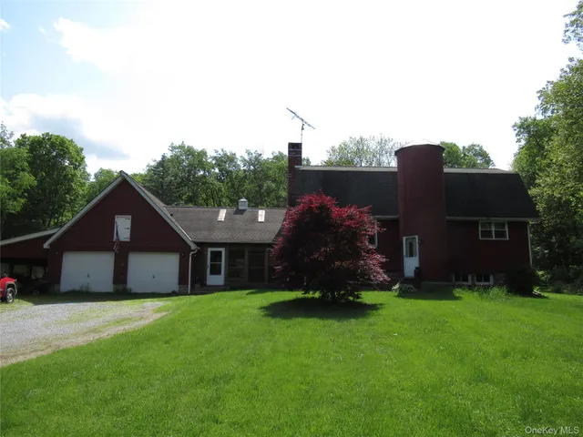 a view of a house with a yard and a garden
