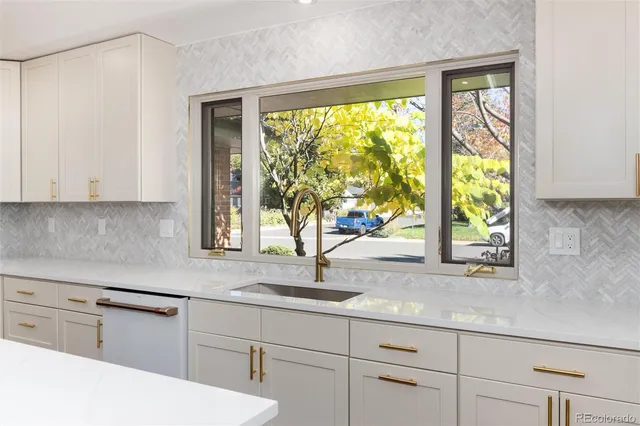 a kitchen with a sink a stove and a wooden floors