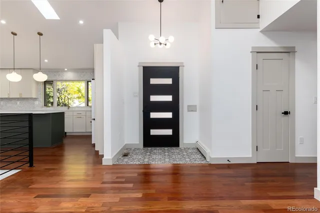 a view of a kitchen with furniture and wooden floor