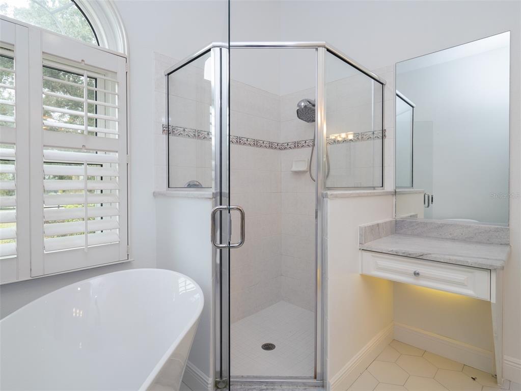 2185 Northwest 114th Loop Ocala, FL 34475 - Photo 12 of 25 a bathroom with a granite countertop sink a toilet and shower