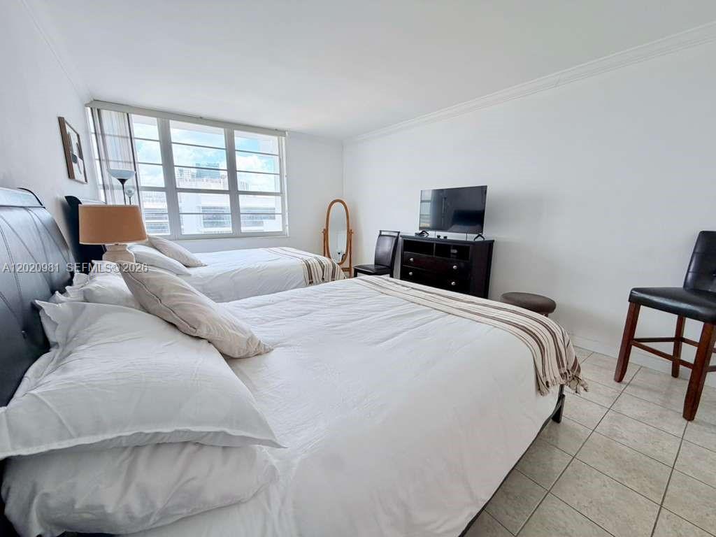100 Lincoln Road, Unit 1423 Miami Beach, FL 33139 - Photo 12 of 17 a bedroom with a bed and a flat screen tv