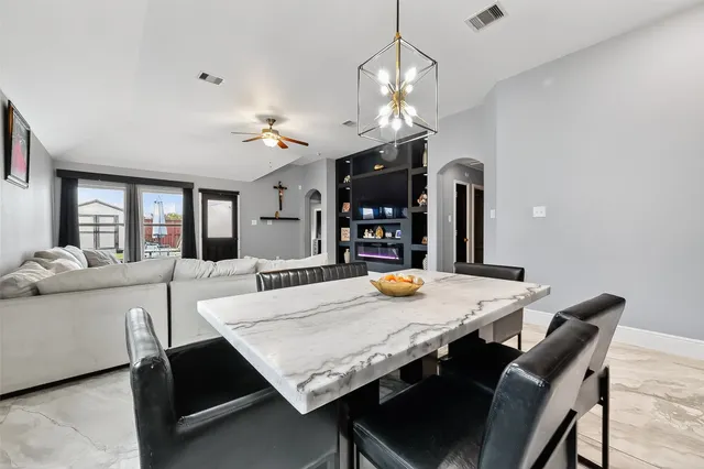 a view of a dining room with furniture and a chandelier