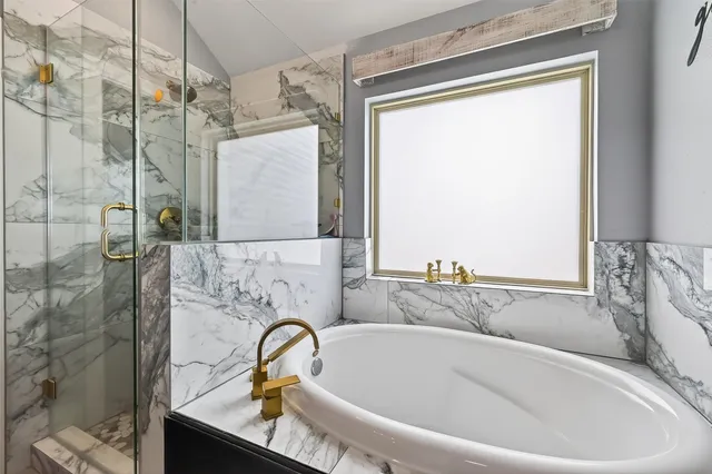 a bathroom with a bathtub and a shower