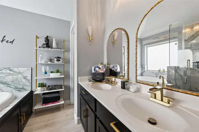 a bathroom with double vanity sinks and a mirror