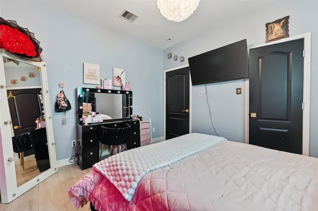 a bedroom with a bed and a television