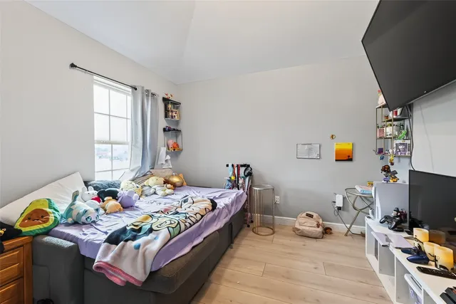 a bedroom with a bed and a flat screen tv