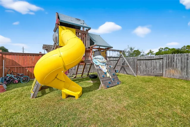 a view of a swimming pool with a chair and table in the patio