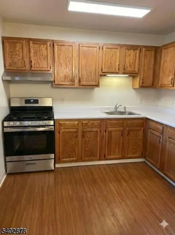 a kitchen with wooden cabinets and a stove top oven