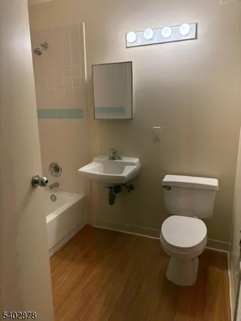 a bathroom with a toilet a sink and mirror