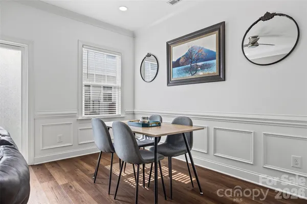 a view of a dining room that has a table and a chair