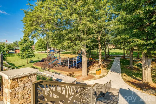 a view of a yard with plants and trees